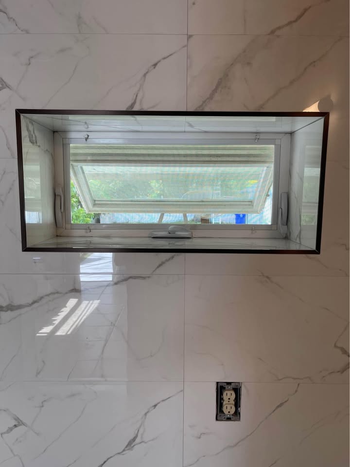 Newly fitted shower with wall panels and a glass door in a Tampa Bay home