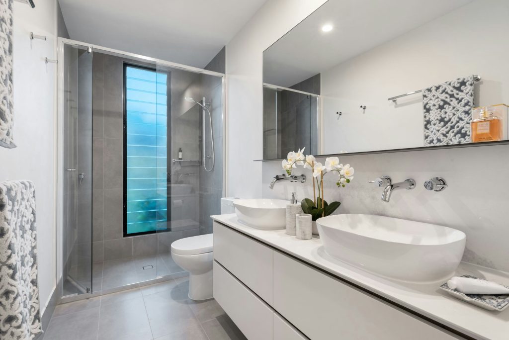 Bathroom remodel completed for a Tampa homeowner with a glass shower screen and tiled walls