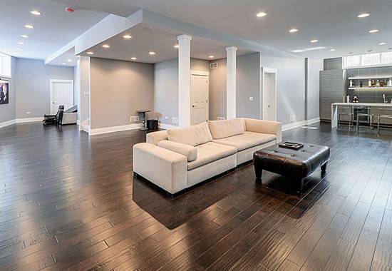 Open commercial interior with dark timber flooring, seating and a fitted bar area